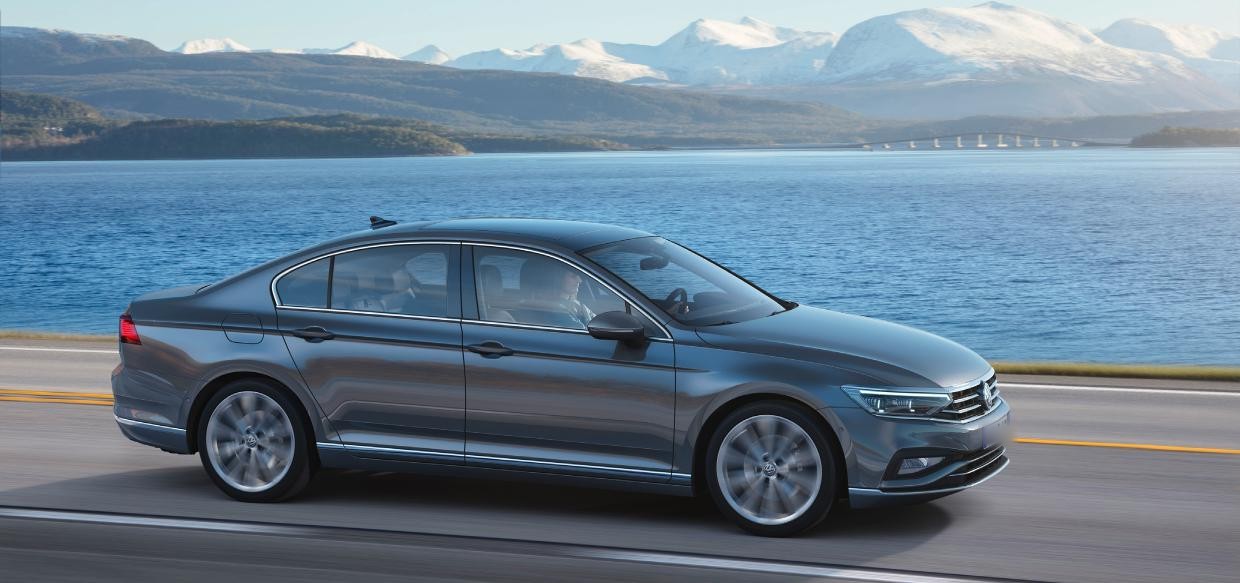 Volkswagen Passat B8 saloon driving on a coastal road